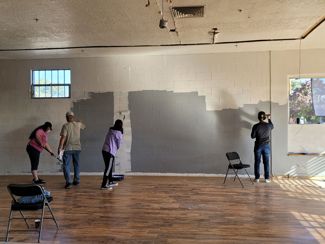 Members of Encuentro Painting a Wall
