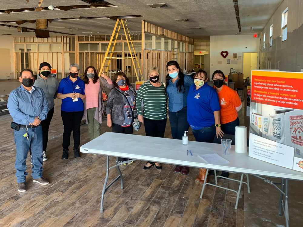 Encuentro team members posing in the new building while it is under construction